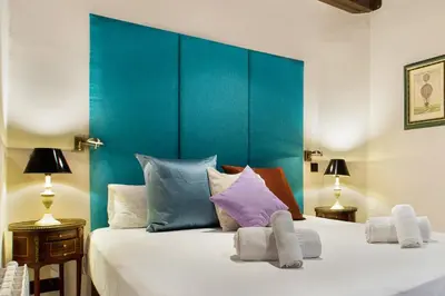 a bedroom with a large bed with a blue headboard at Stay U-nique Apartments Carretes in Barcelona