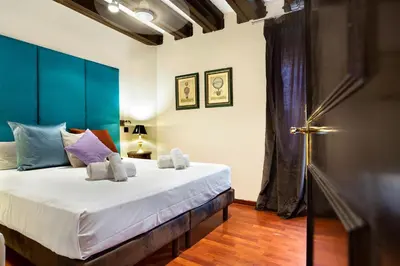 a bedroom with a large bed with a blue headboard at Stay U-nique Apartments Carretes in Barcelona