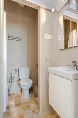 a white bathroom with a toilet and a sink at Stay U-nique Apartments Pasteur in Barcelona