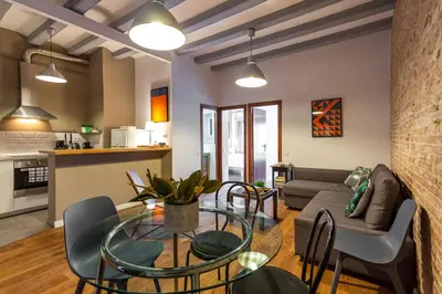 a living room with a glass table and a couch at Stay U-nique Apartments Parlament in Barcelona