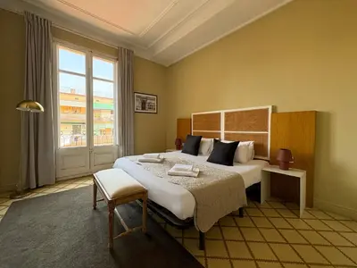 a bedroom with a large bed and a large window at Stay U-nique Apartments Gran Via in Barcelona