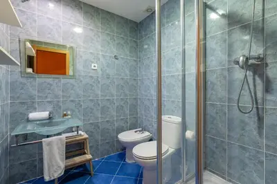 a bathroom with a toilet and a glass shower at Stay U-nique Apartments Passatge de Font in Barcelona