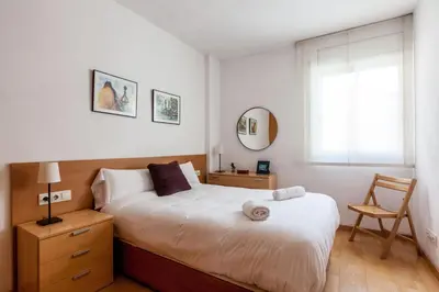 a bedroom with a large bed and a window at Stay U-nique Apartments Industria in Barcelona