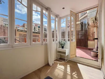 an empty room with windows and a view of a city at Stay U-nique Apartments Rocafort in Barcelona