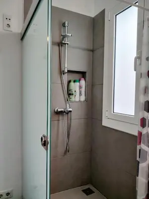 a bathroom with a shower with a glass door at Stay U-nique Apartments Sagues in Barcelona
