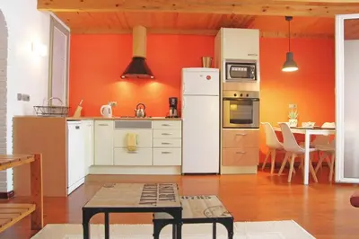 a kitchen with a white refrigerator and a table at Urban Loft Barcelona Diagonal super ubicación wifi in Barcelona