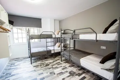 a room with three bunk beds and a window at Catalunya Casas Relax and Recharge - only 34km from Barcelona! in Rubí