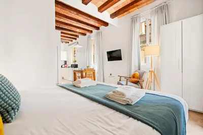a bedroom with a bed with towels on it at Lodging Apartments Barceloneta Beach Studio P2 in Barcelona
