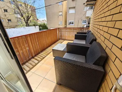 a balcony with two chairs and a fence at Apartamento Playa con Piscina y 2 habitaciones in Castelldefels