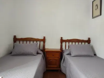 two beds sitting next to each other in a room at a18' de Barcelona y 10' de circuito de Cataluña in Barcelona