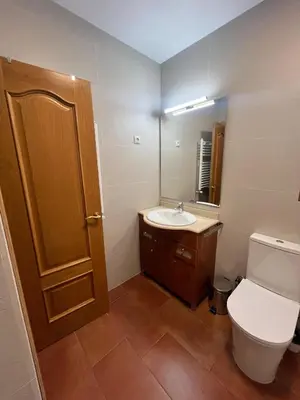 a bathroom with a toilet and a sink and a mirror at a18' de Barcelona y 10' de circuito de Cataluña in Barcelona