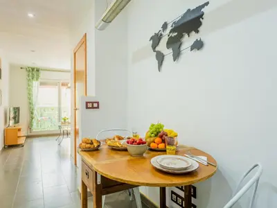 a dining room with a table with fruit on it at Matarolux20 in Mataró