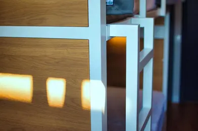 a close up of a wooden door with the light shining on it at Factory Hostels Barcelona in Barcelona