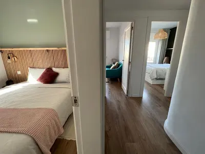a bedroom with a bed and a room with a mirror at Charming appartement in the heart of Barcelona in Barcelona