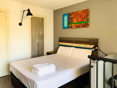 a bedroom with a bed with towels on it at Incredible 2BR Penthouse with Urban Rooftop Garden in Barcelona