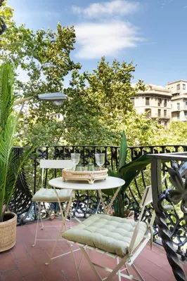 a table and two chairs on a balcony at La Maison de Barcelone in Barcelona