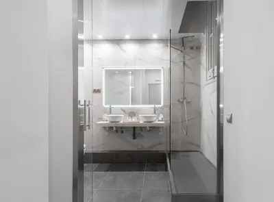 a bathroom with a sink and a mirror and a shower at La Maison de Barcelone in Barcelona