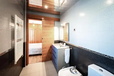 a bathroom with a sink and a toilet and a mirror at InSitges Ribera's Beach in Sitges