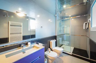 a bathroom with a sink and a toilet and a mirror at InSitges Ribera's Beach in Sitges