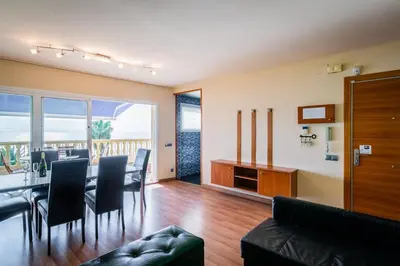 a living room with a table and chairs and a dining room at InSitges Ribera's Beach in Sitges