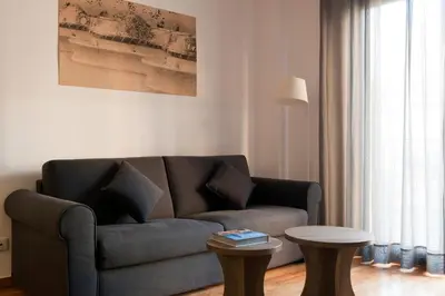 a living room with a couch and a table at MH Apartments Gracia in Barcelona