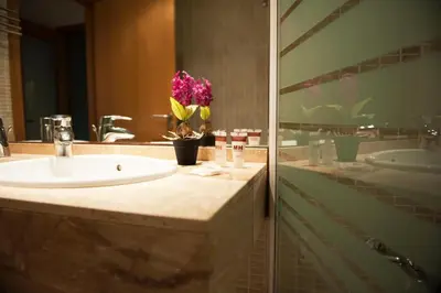 a bathroom with a sink and a mirror at MH Apartments Gracia in Barcelona