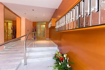 a staircase in a building with some flowers at Sweet Apartments in Sant Pere de Ribes