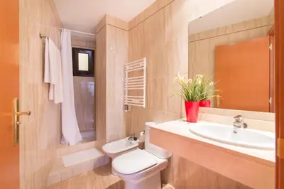 a bathroom with a white toilet and a sink at Sweet Apartments in Sant Pere de Ribes