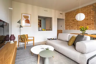 a living room with a couch and a table at Aspasios Garden Apartments in Barcelona