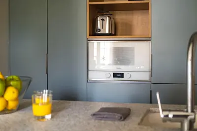 a kitchen counter with a sink and a microwave at Aspasios Garden Apartments in Barcelona
