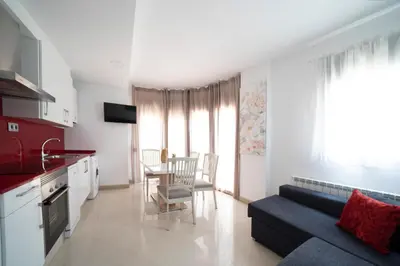 a kitchen and living room with a couch and a table at Kisa Apartments de Manresa in Manresa