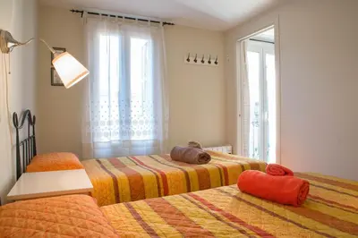a bedroom with two beds and a window at Barcelona4Seasons - Gavina in Barcelona
