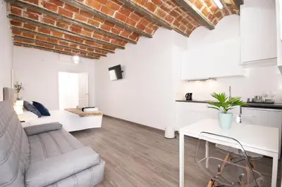 a living room with a couch and a table at Apartahotel Casa Batito in Hospitalet de Llobregat