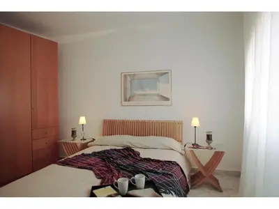 a bedroom with a bed with two tables and two lamps at ClassBedroom Gaudí Apartments in Barcelona