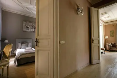 a room with a bedroom with a bed and a chandelier at Enjoy Apartments Gran Via in Barcelona
