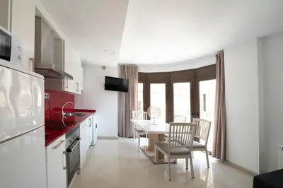 a kitchen and dining room with a table and chairs at Apartamento Arbones de Manresa in Manresa