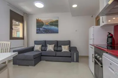 a living room with a couch in a kitchen at Apartamento Arbones de Manresa in Manresa