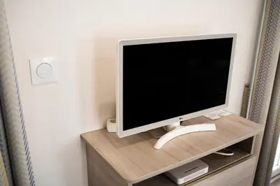 a computer monitor sitting on top of a wooden shelf at Camping Bellsol Pets in Pineda de Mar