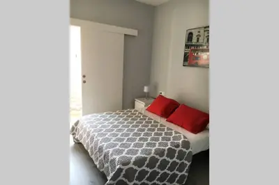 a bedroom with a bed with two red pillows at sagrada familia gaudi in Barcelona