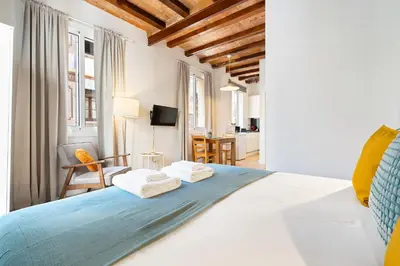a bedroom with a bed with towels on it at Lodging Apartments Beach Studio 11 in Barcelona
