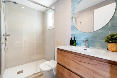 a bathroom with a toilet and a sink and a mirror at Lodging Apartments Beach Studio 41 in Barcelona