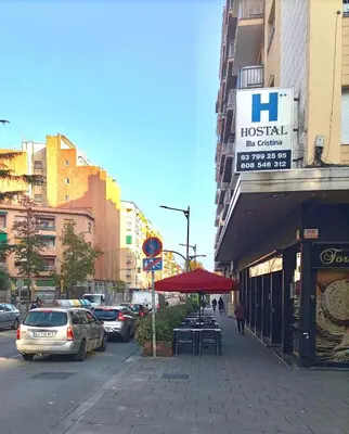 a street with cars parked on a city street at Hostal Isla Cristina Mataro in Mataró