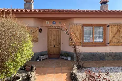 a home with a wooden door and a patio at Vino que del Cielo Vino. Alt Penedès (País del Cava) Barcelona in San Quintín de Mediona