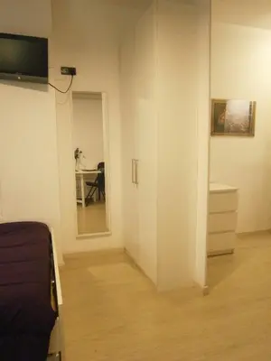 a room with a bed and a table and a mirror at Marbel Apartments in Barcelona
