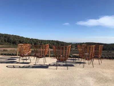a group of chairs sitting on top of a roof at Hotel Montrubí 1771 - Slow Winery Hotel - Adults only in Font-Rubí