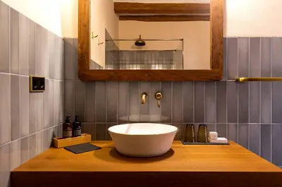 a bathroom with a large white bowl sink on a counter at Hotel Montrubí 1771 - Slow Winery Hotel - Adults only in Font-Rubí