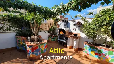 an outdoor patio with a fireplace and plants at Apto, Ático Airport BCN, Cruise Port, Near beaches in Viladecáns