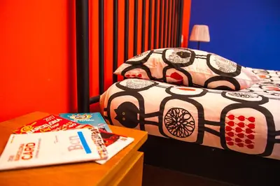 a bedroom with a bed and a nightstand with a table at Apartamento Rosellón in Barcelona