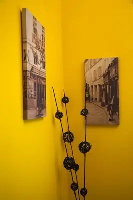 a yellow wall with some black objects on it at Apartamento Rosellón in Barcelona