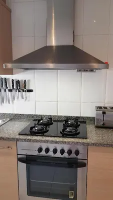 a kitchen with a stove top oven in a kitchen at Apartamento Mediterraneo in Pineda de Mar